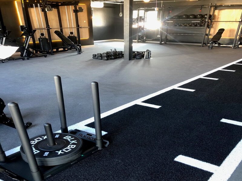 gym sled push on artificial turf tiles