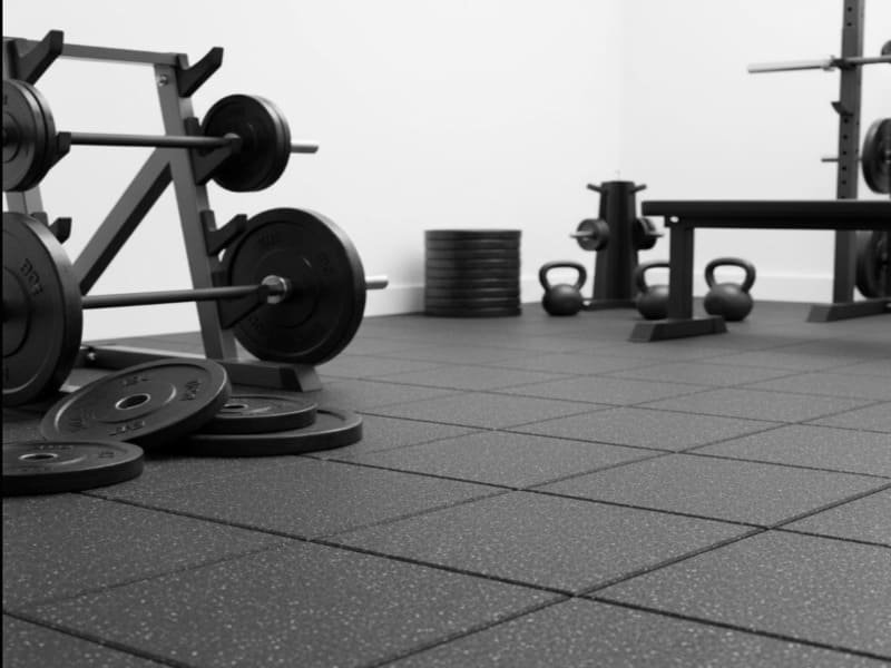 High-density rubber tiles next to weight plates