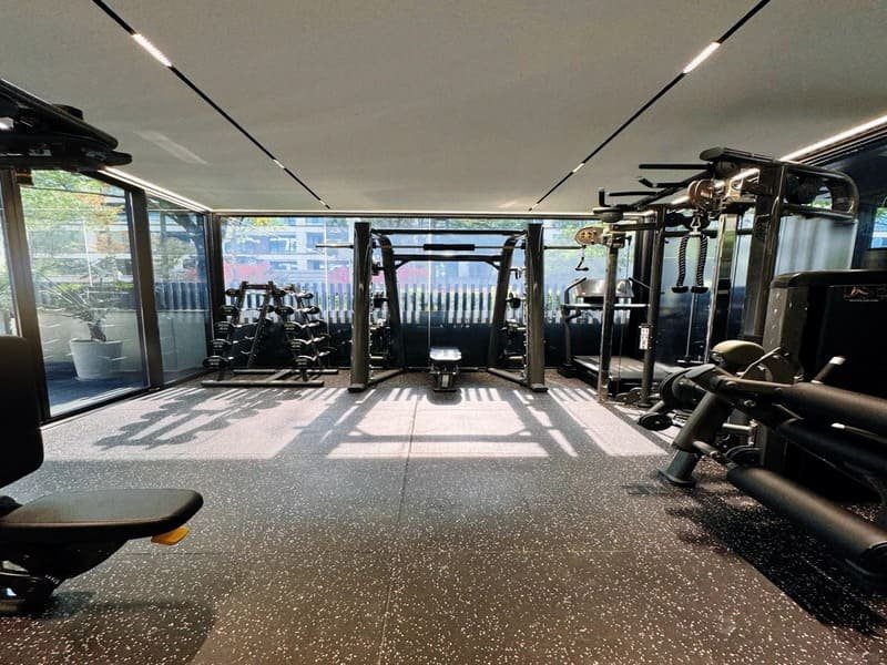 Hand pressing thumb into rubber gym mat to test resilience and rebound speed